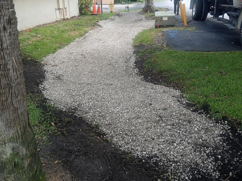 Finished curved gravel walkway with clean lawn edges