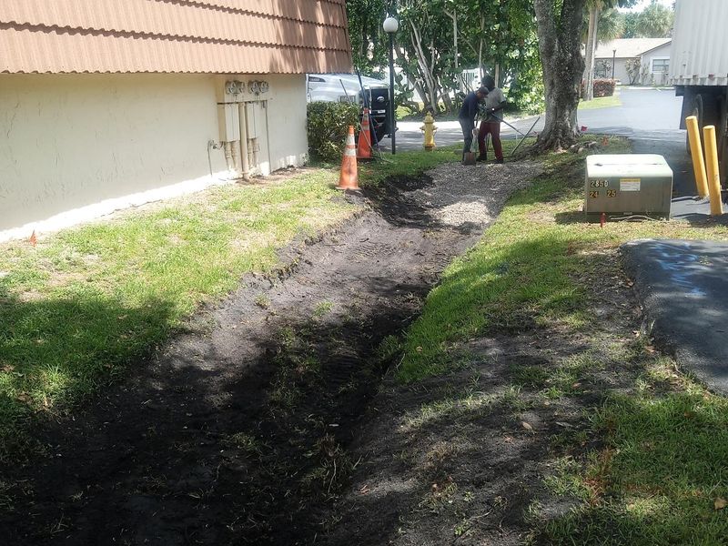 Excavated path area beside a building before walkway installation