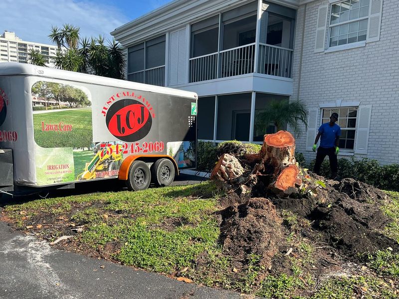 Stump grinding at a condominium with the Just Call James trailer on site